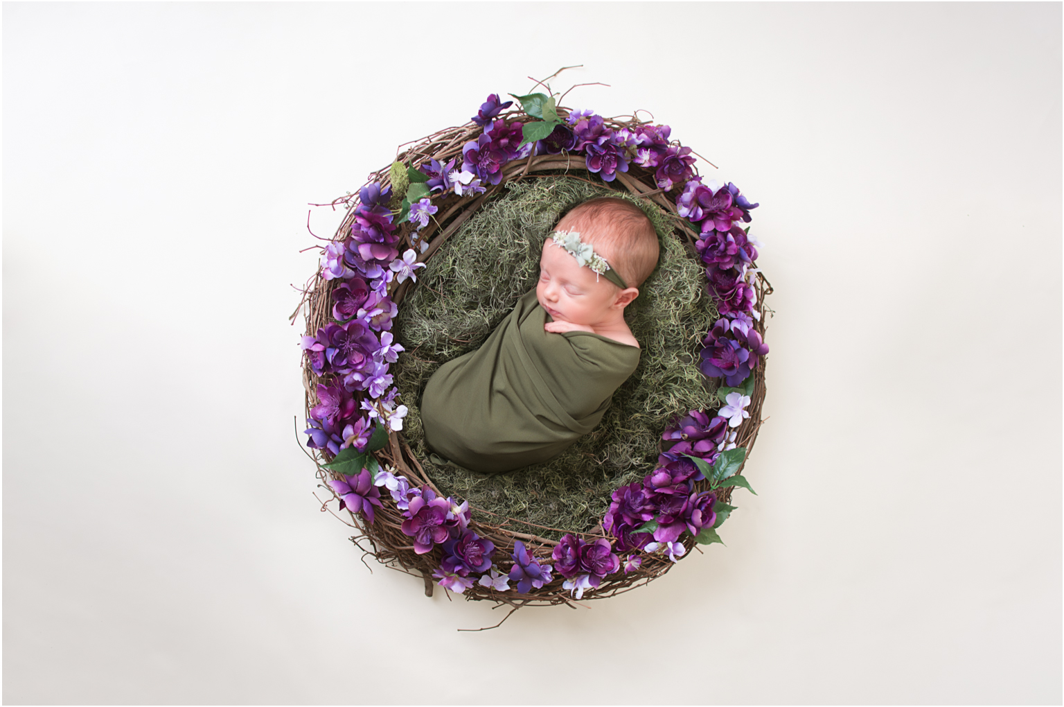 Juliann in greens and purple florals all snuggled in a wreath 