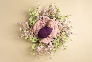 Juliann Pink and green floral wreath with purple wrap