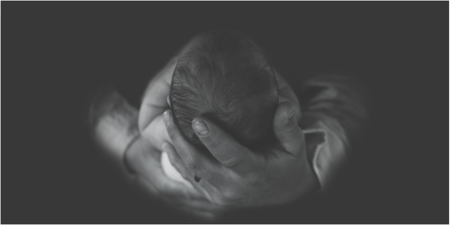 Baby Amia Daddys hands infant black and white